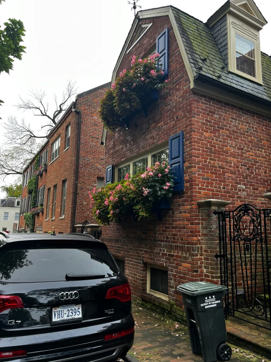 a very tall brick building with a bunch of window boxes in front