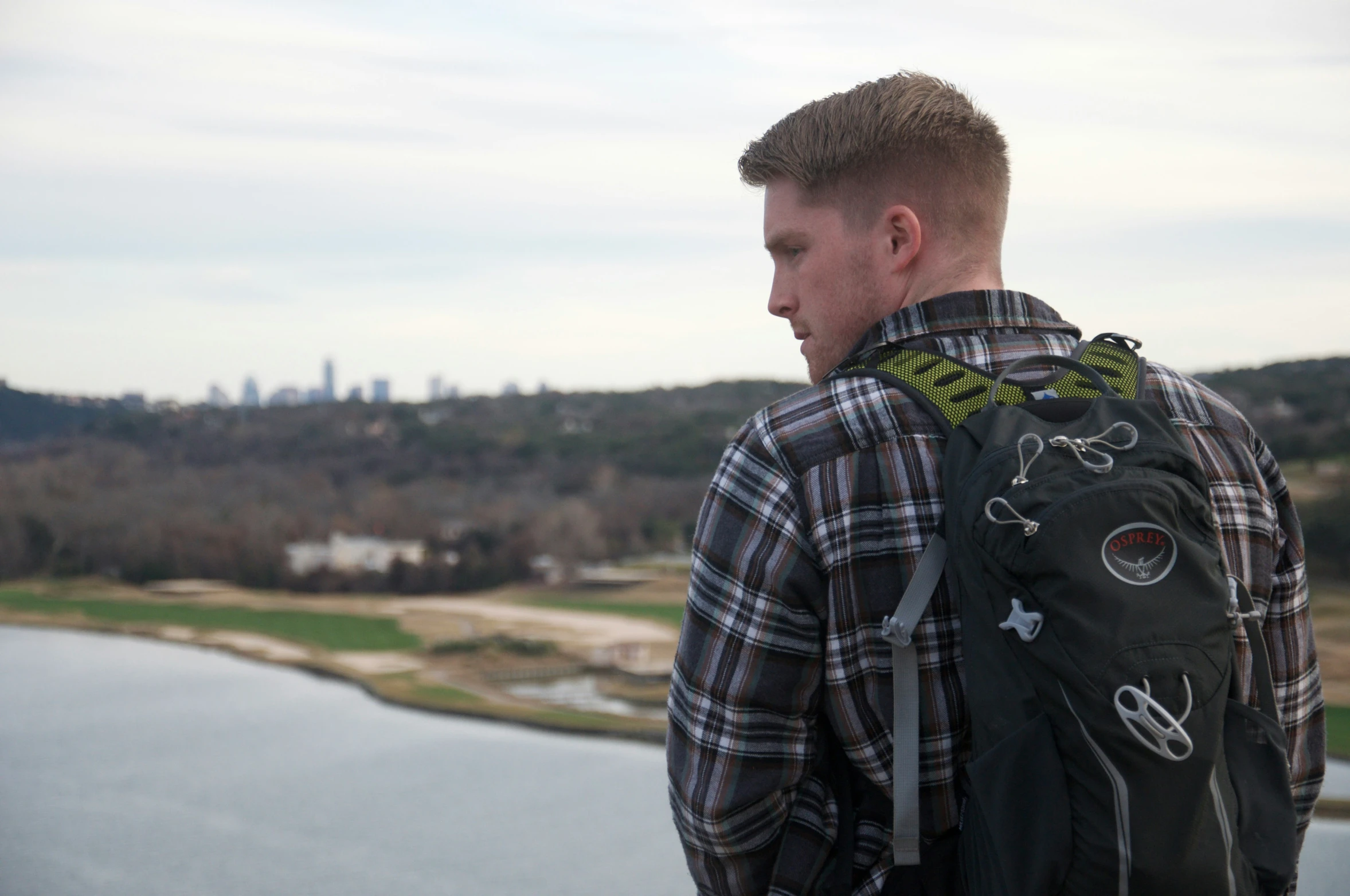 the man looks out over a lake