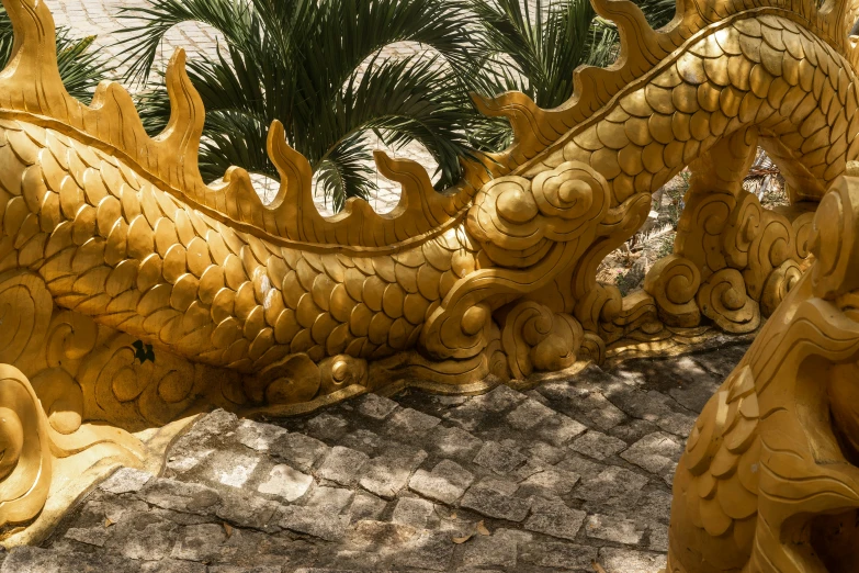 gold dragon statue sitting on top of the roof