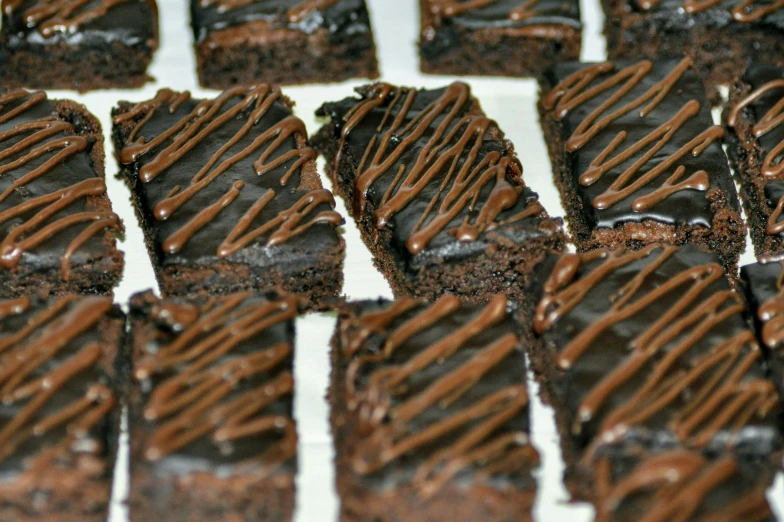 a tray of chocolate squares on a white table