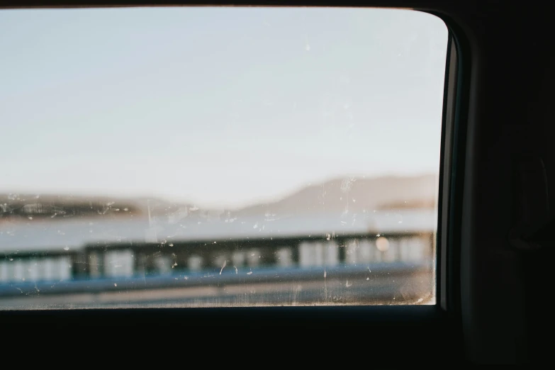 an out of focus window view of buildings and water