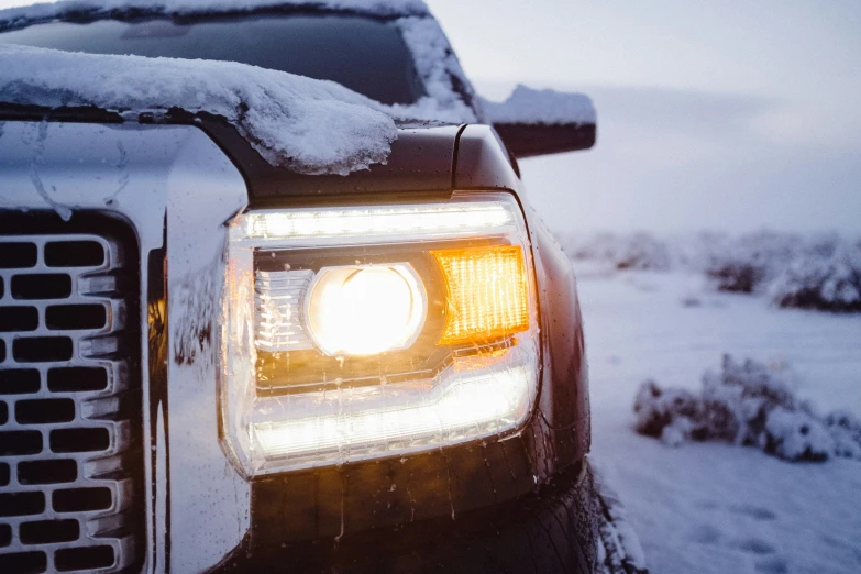 the front end of a pickup truck in snow