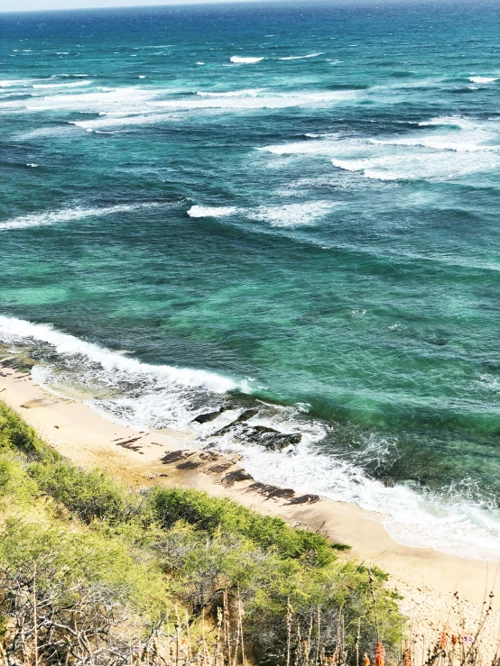 the beach on the other side of the hill with some water