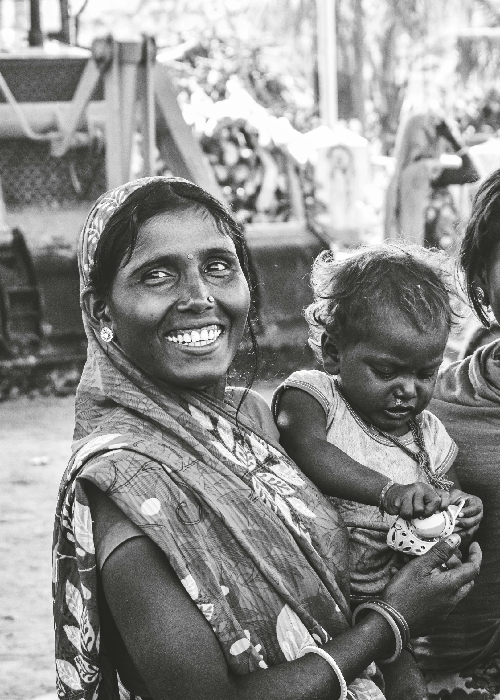 three woman smile and smile with a baby