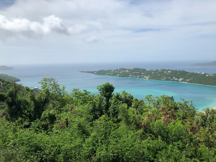 a scenic view of an island and a turquoise ocean