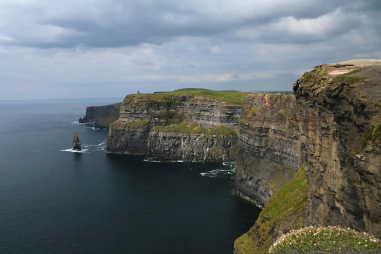 the rocks have been stacked high into the cliffs near the ocean