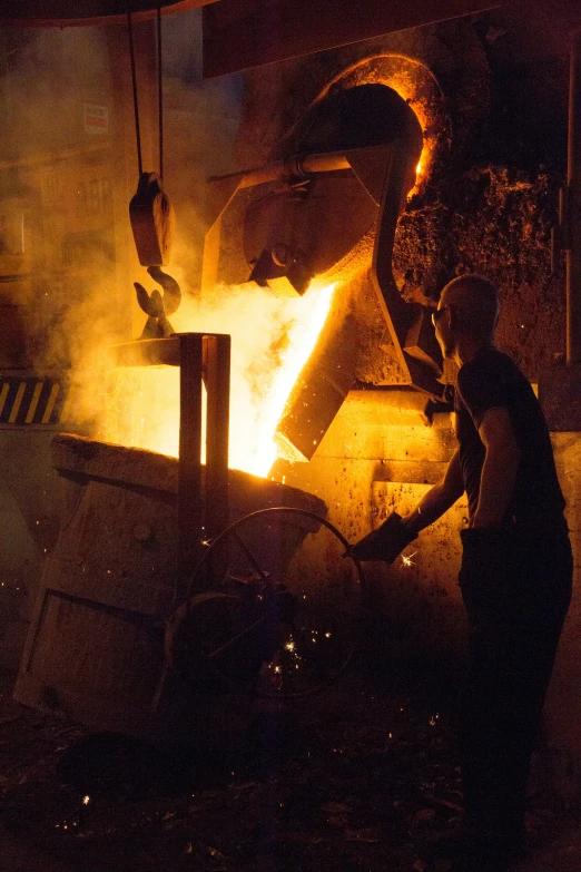 a person working on metal in a factory