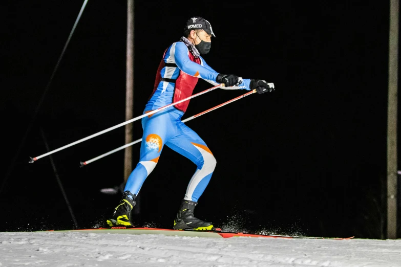 a person skiing down a snow covered ski slope