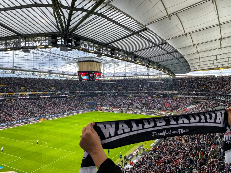 a soccer stadium full of fans with a banner