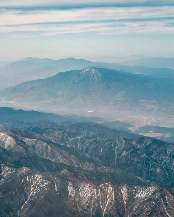 a mountain range is seen from a plane window