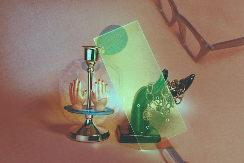 a pair of green high heeled shoes next to a glass card holder