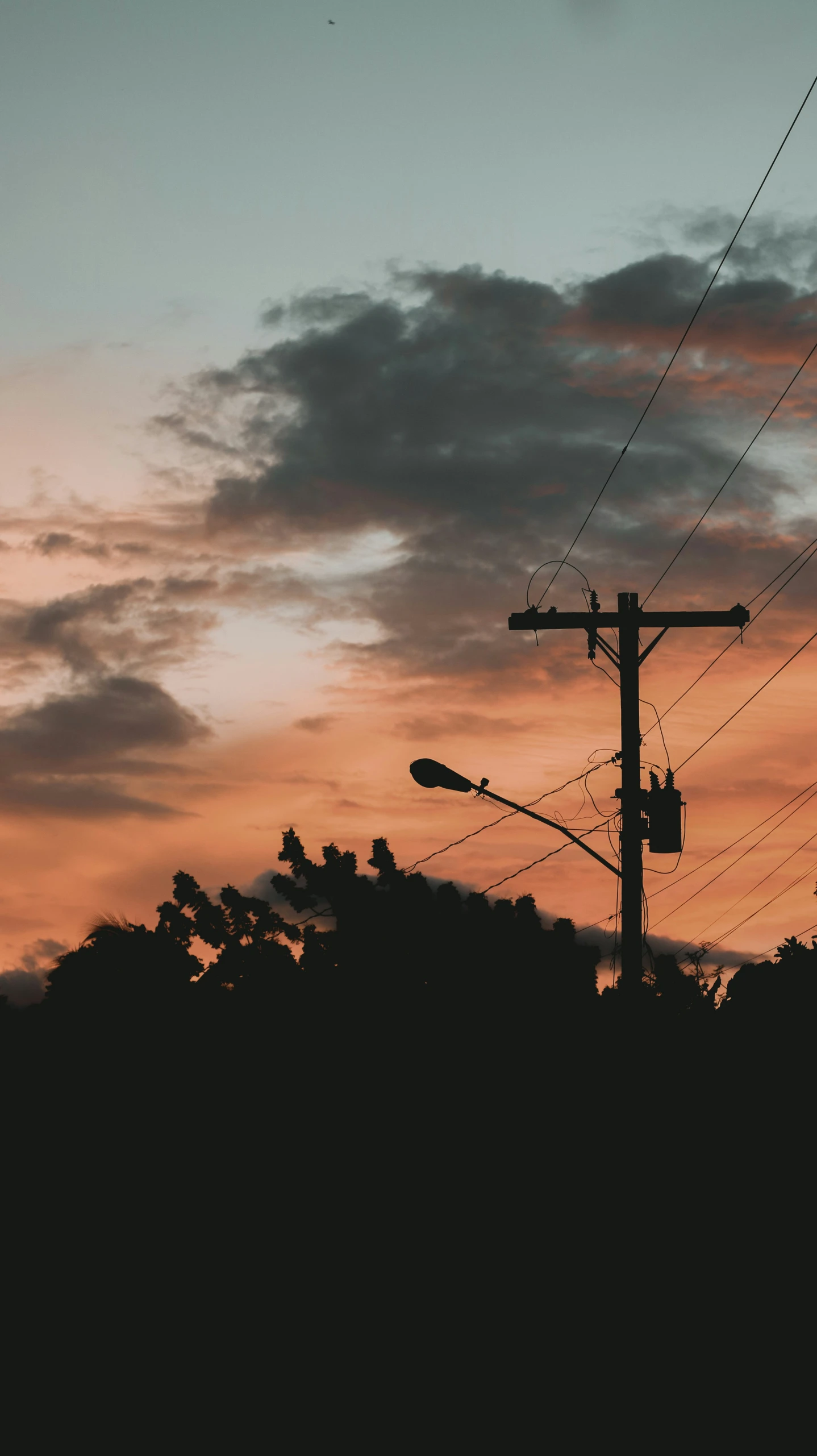 a street lamp next to a telephone pole