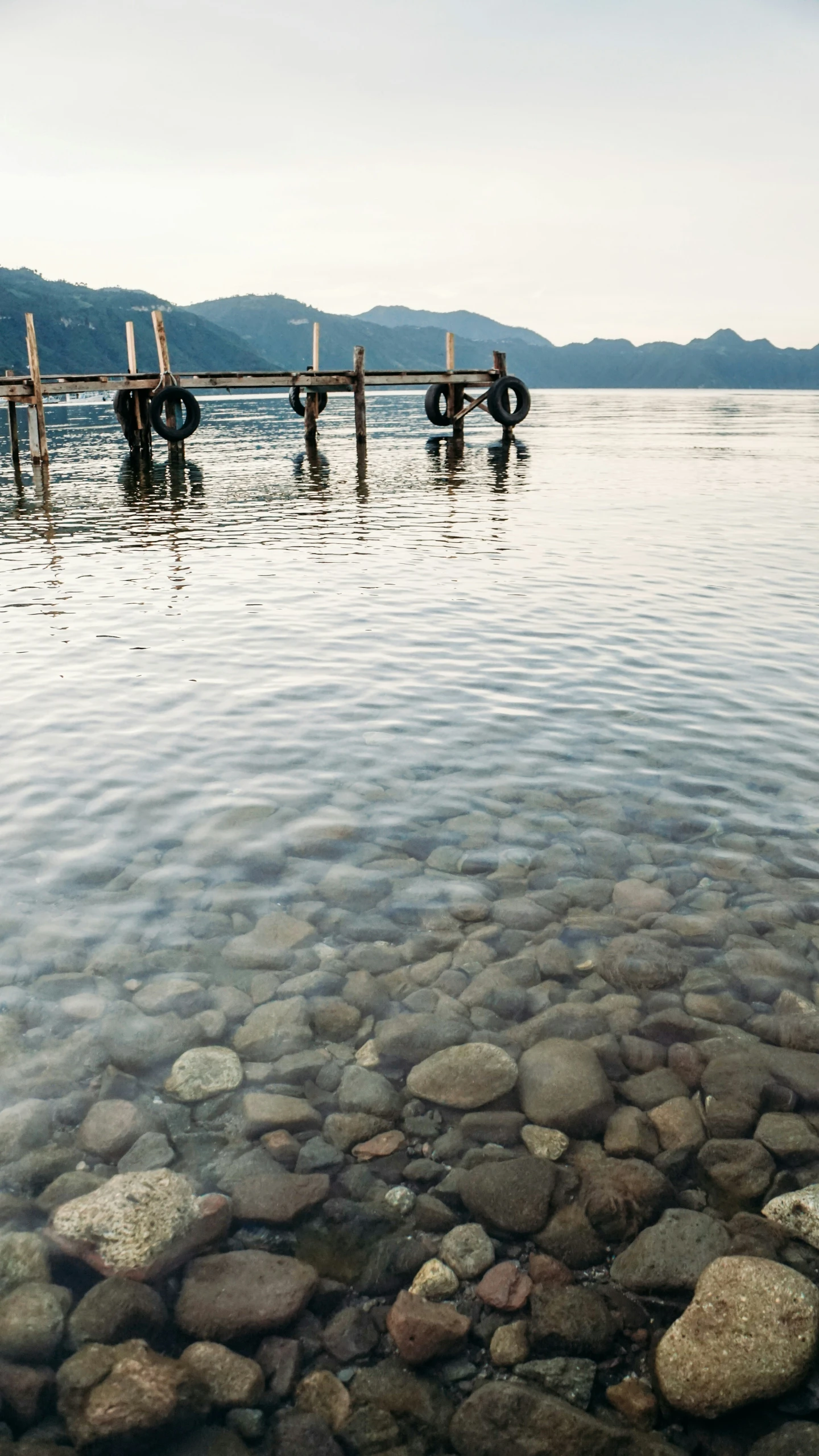 some rocks and a boat on a river