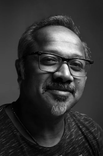 an older man wearing glasses and a striped shirt