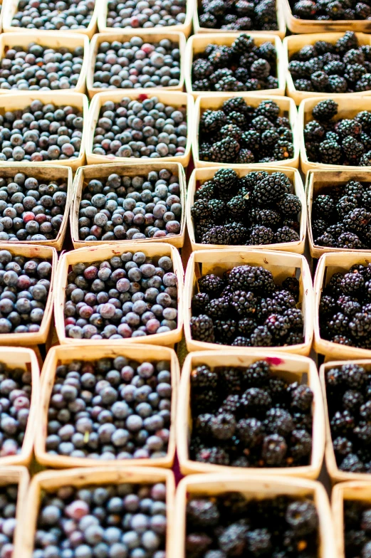 some baskets filled with berries sitting on top of a table