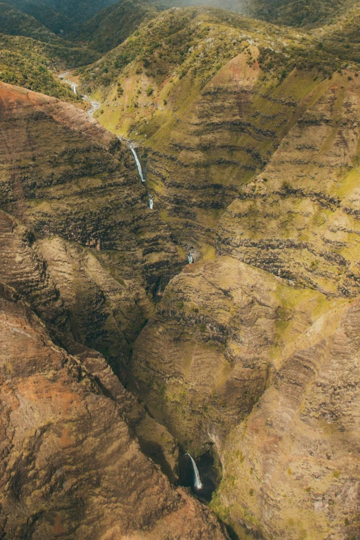 an aerial view of a large mountain with a waterfall