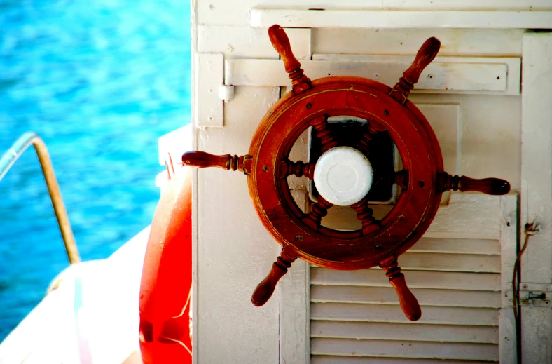 a boat steering wheel on the back side of the ship