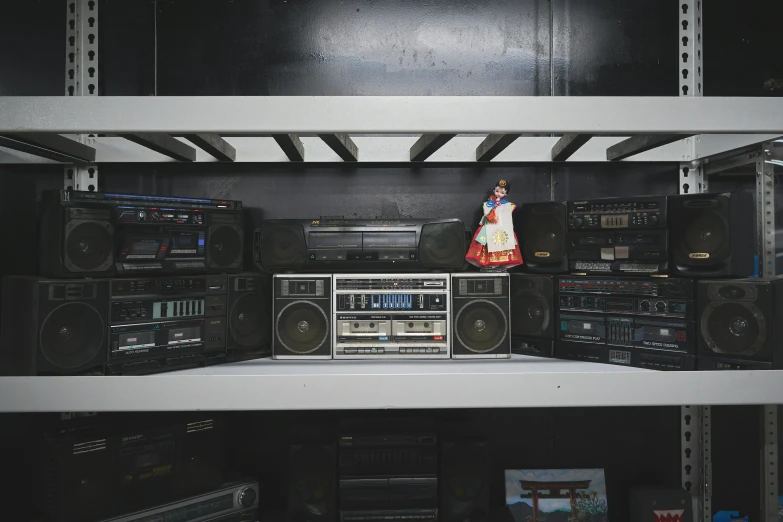 a shelf full of electronic equipment inside of a room