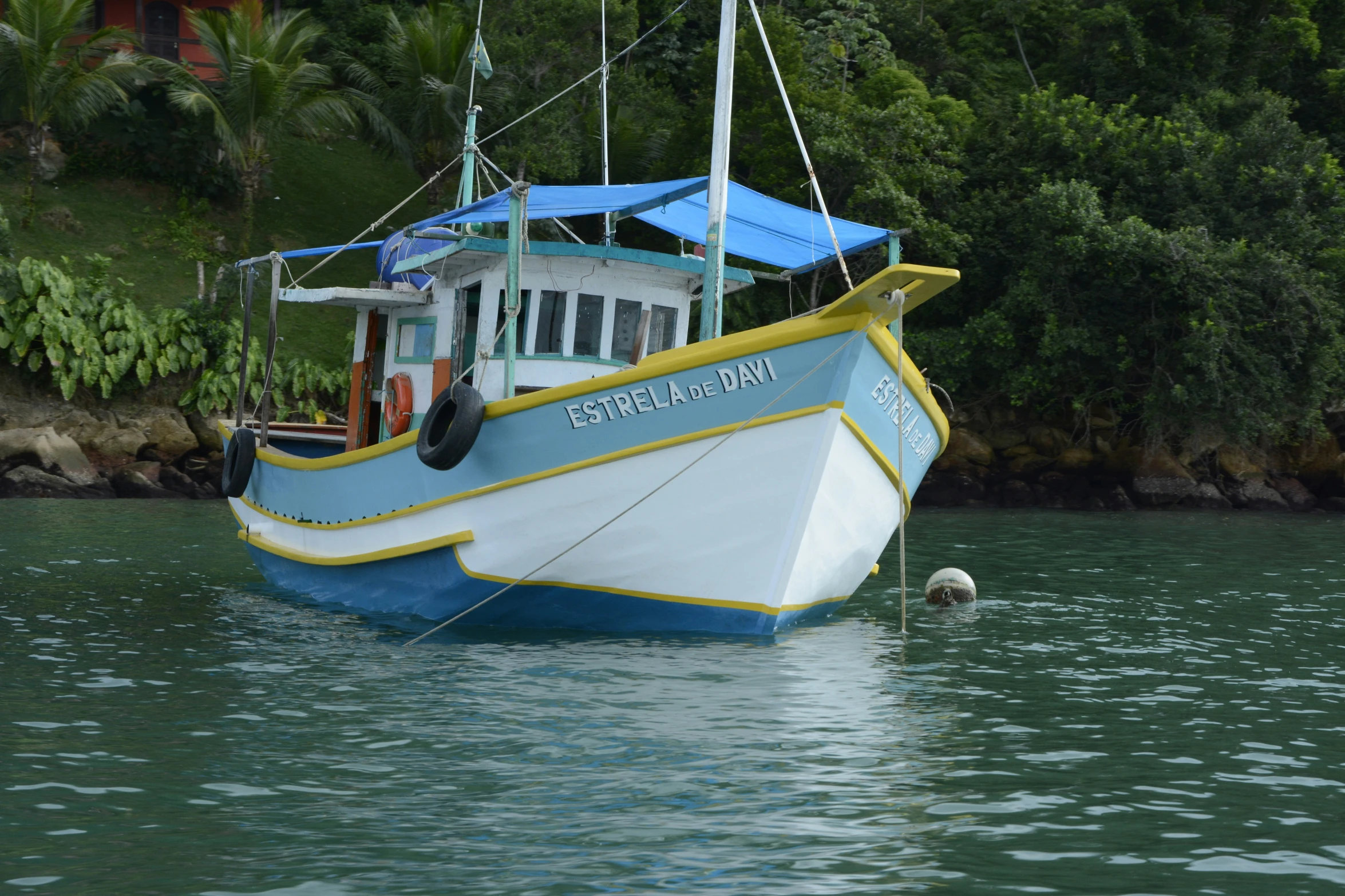 a boat floating on the water near land