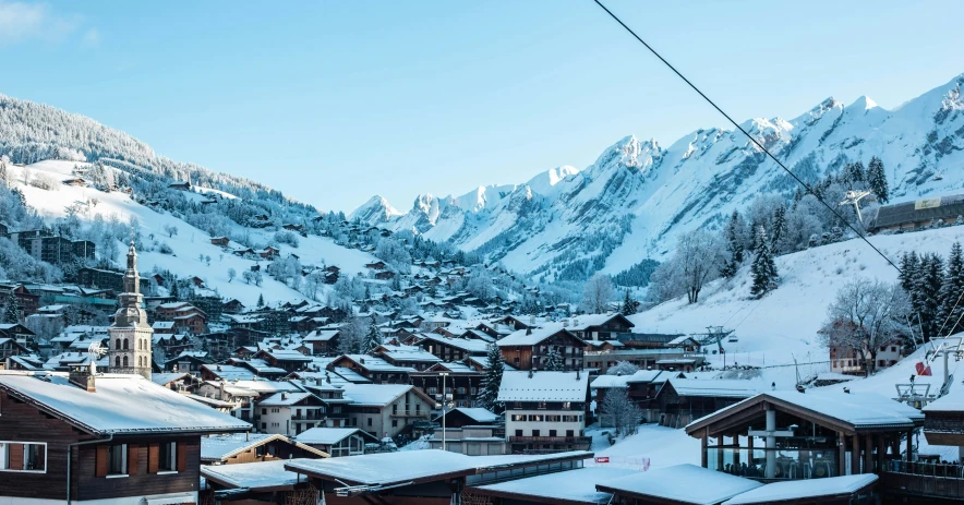 snowy mountain town in the winter with blue sky