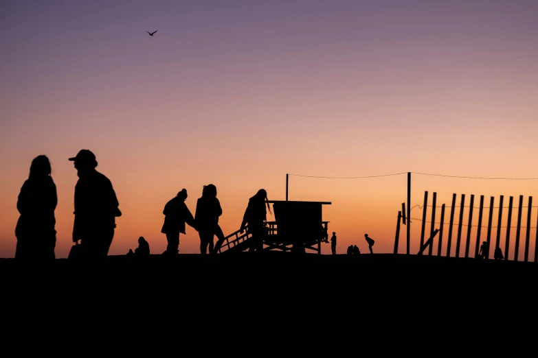 silhouettes of people with a fire hydrant against a dark sky