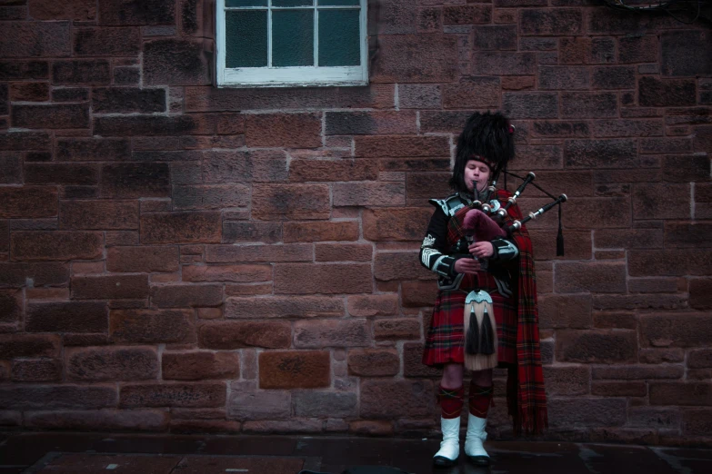 a man wearing a kilt and playing the bagpipe