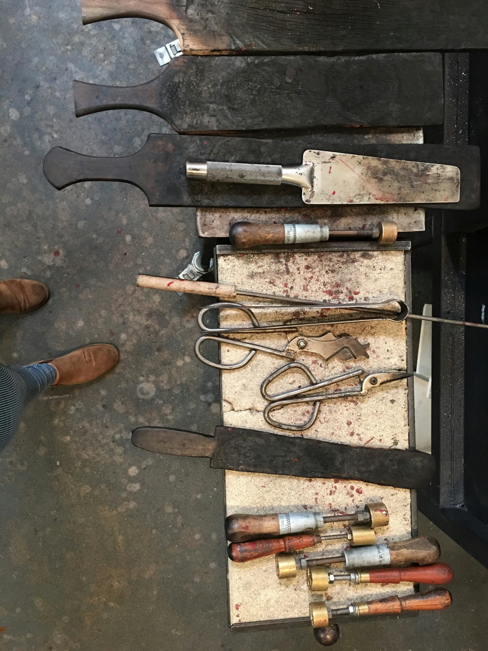 several different tools arranged on display in the shape of a cabinet