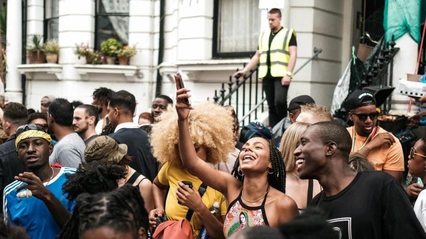 group of people standing in street with police in the background