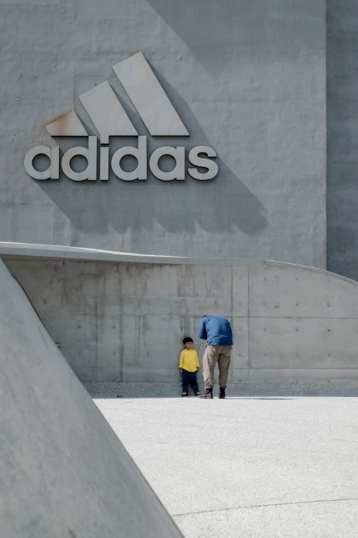 two people are standing in front of a sign