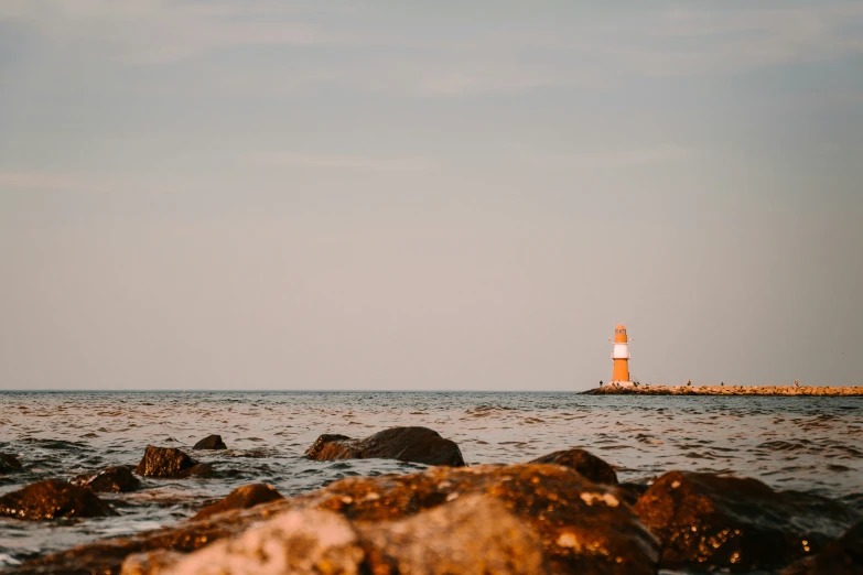 the view of the light house is from the rocks