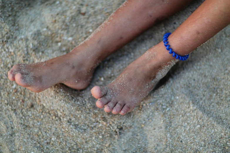 a person is in the sand with dirt on their legs