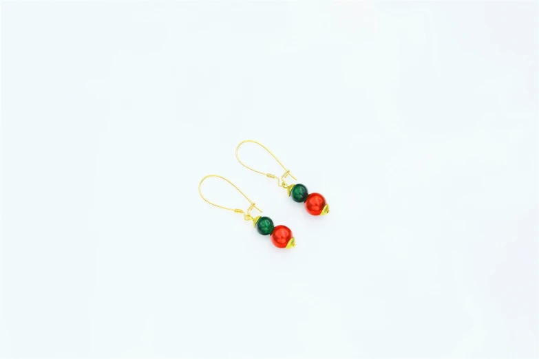 the earrings have red and green beads and gold chains