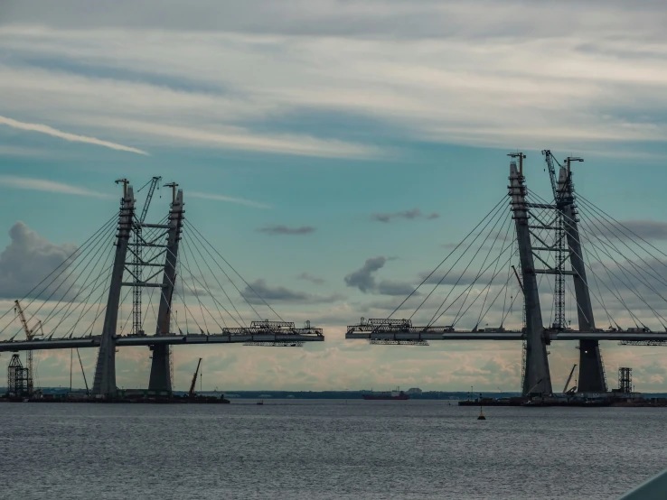 two huge towers are towering over the water