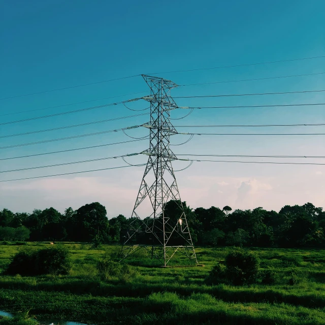 a tower in the middle of a field of grass