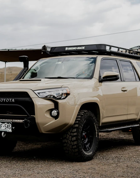 a beige four door toyota suv with a flat tire