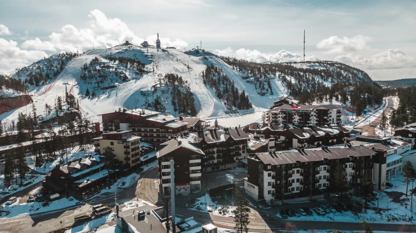 an aerial view of a mountain resort with a ski area at the bottom