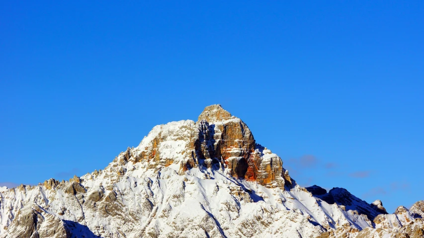 a snow capped mountain with a clear sky in the background