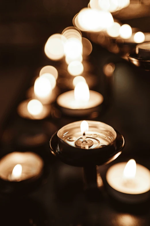 many candles lit on top of each other in different shapes