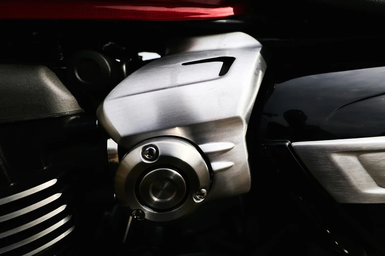 the front view of a silver motorbike with black and white stripes