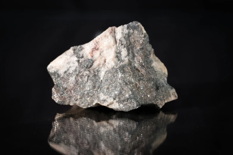 a piece of rock on black background with reflection