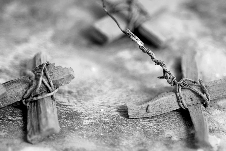 black and white pograph of a broken wooden cross