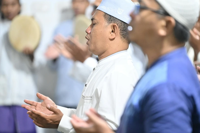 a group of people clapping with hats and their hands