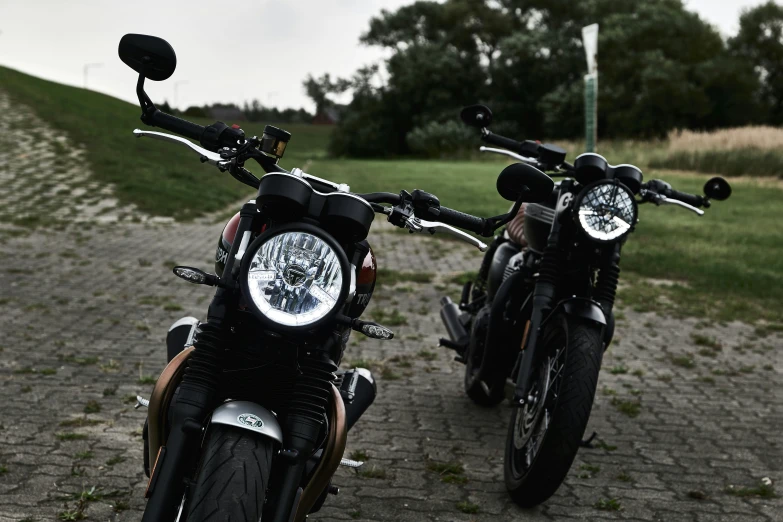 the motorcycles are parked outside by the grassy field