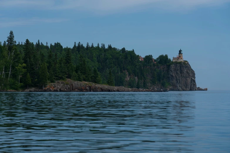 a lighthouse on top of a rock in a lake