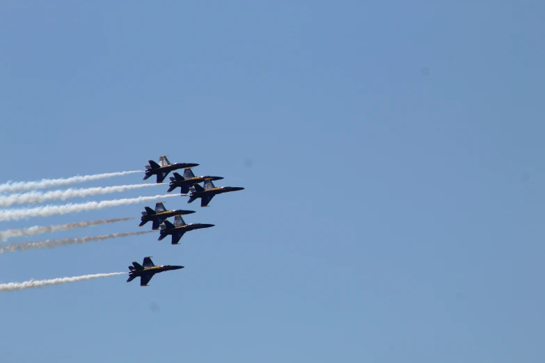 four jets in formation flying in formation through the sky