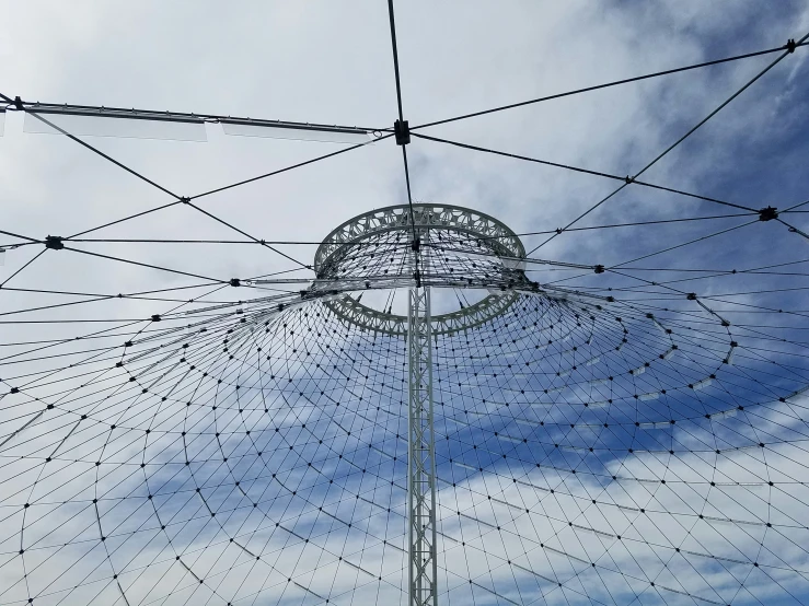 the top of a structure with a cloudy blue sky in the background