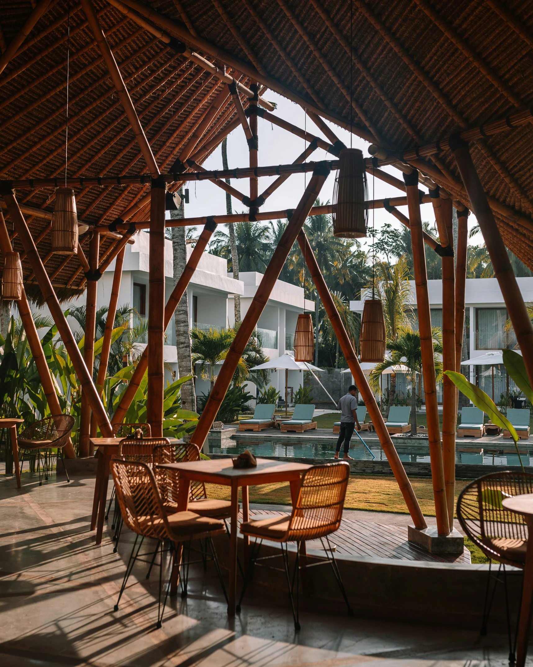 a patio filled with lots of wooden furniture