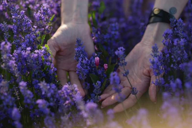 the woman is holding a bunch of flowers