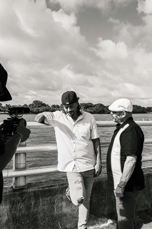 two people taking pictures in black and white