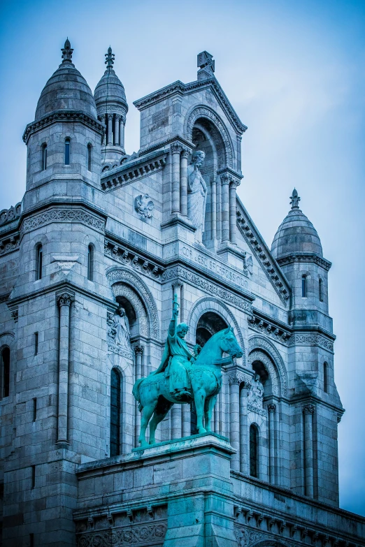 a blue picture of a building with a statue on it